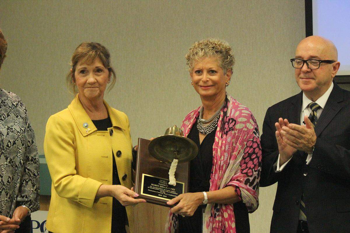 Robin DiSabatino received a ship’s bell plaque at her last meeting Thursday as a member the Manatee County Port Authority. Also shown are Vanessa Baugh, left, and Carlos Buqueras.