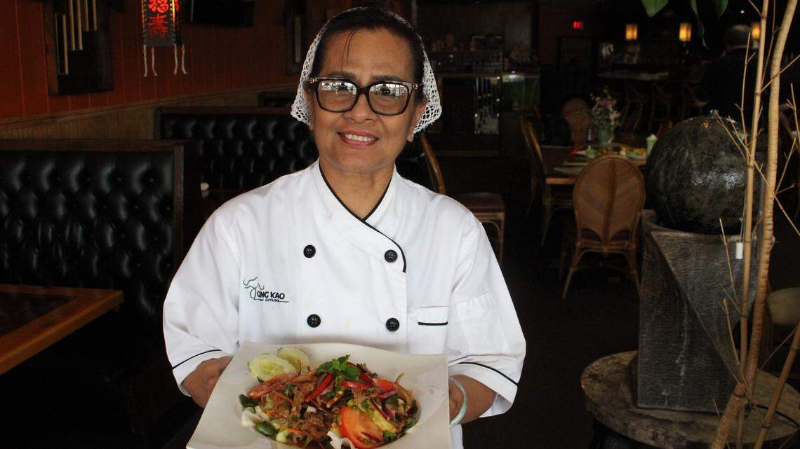 Chef and Chang Kao Thai Cuisine co-owner Pacharee Tunkanitlert holds a plate of Yum Nua, a salad made of grilled sliced beef with red onion, tomato, cucumber, red bell pepper, scallion, cilantro, mint, chili and sour lime juice.