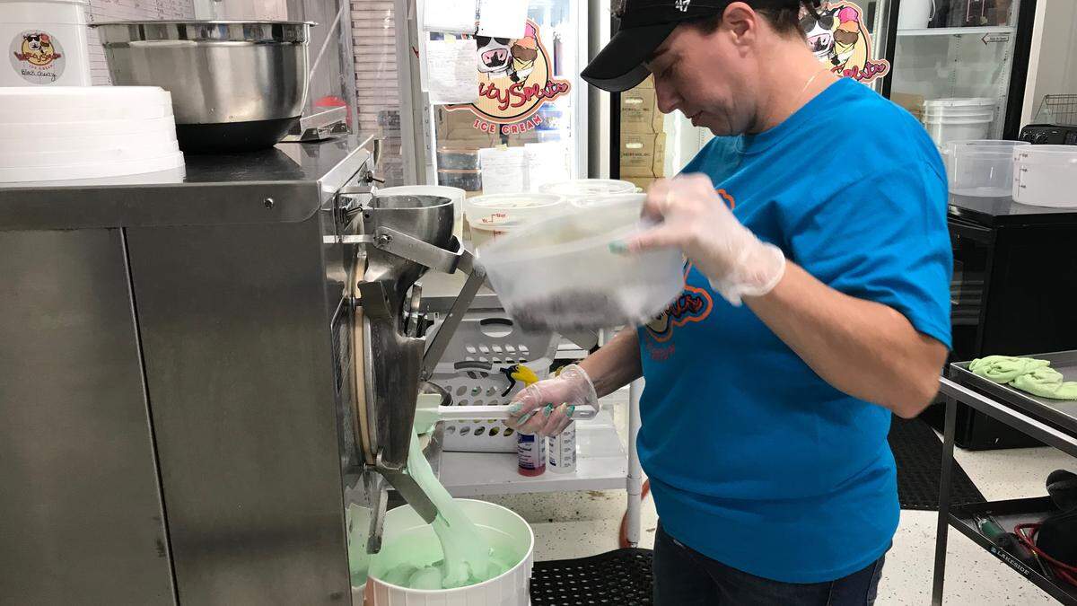 Crystal Stephens readies the chocolate chips for the mint ice cream Thursday at the Lickity Splits plant. Several different flavors were being made and poured into 2 1/2 gallon tubs.
