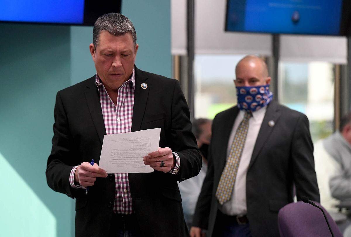 02/18/21--A special agent with the FDLE served subpoenas to four commissioners ahead of ThursdayÕs public work session meeting. Commissioner George Kruse reads the subpoena before sitting down.
