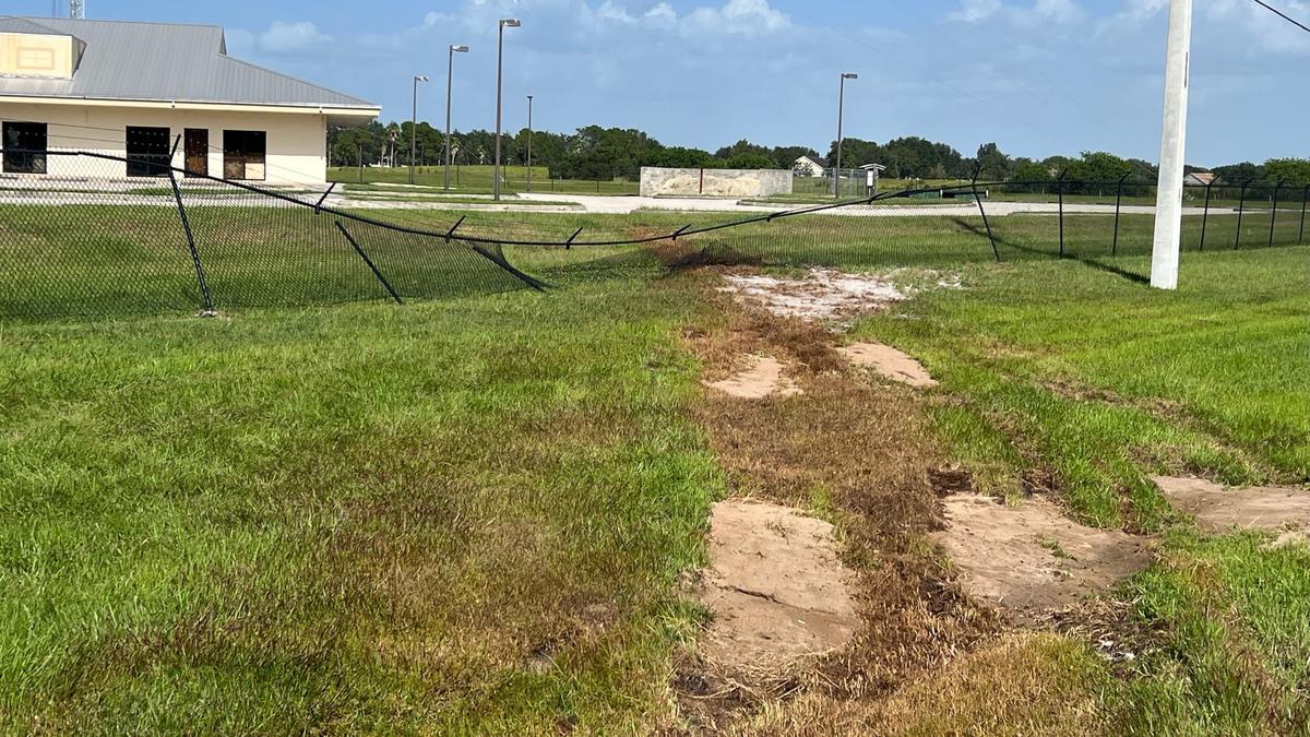 A dump truck recently rolled through the County Road 675-Rye Road intersection and knocked down a chain link fence on the north side of the road near a closed Foxbrook retail area.