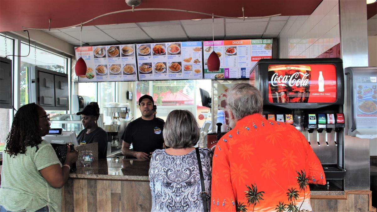 Customers line up to place their orders at Sam’s Seafood & Grill at 3108 First St., Bradenton. The new restaurant has been open for about one month.