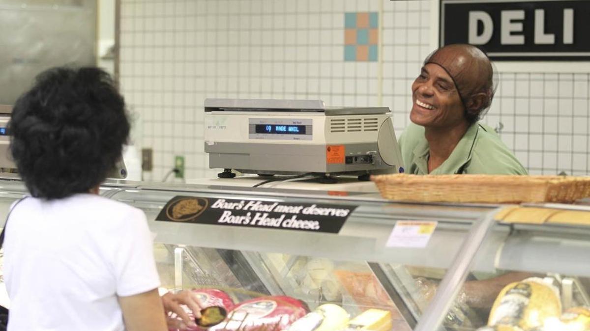A deli clerk at the Publix in Coral Gables serves a customer in August 2012.