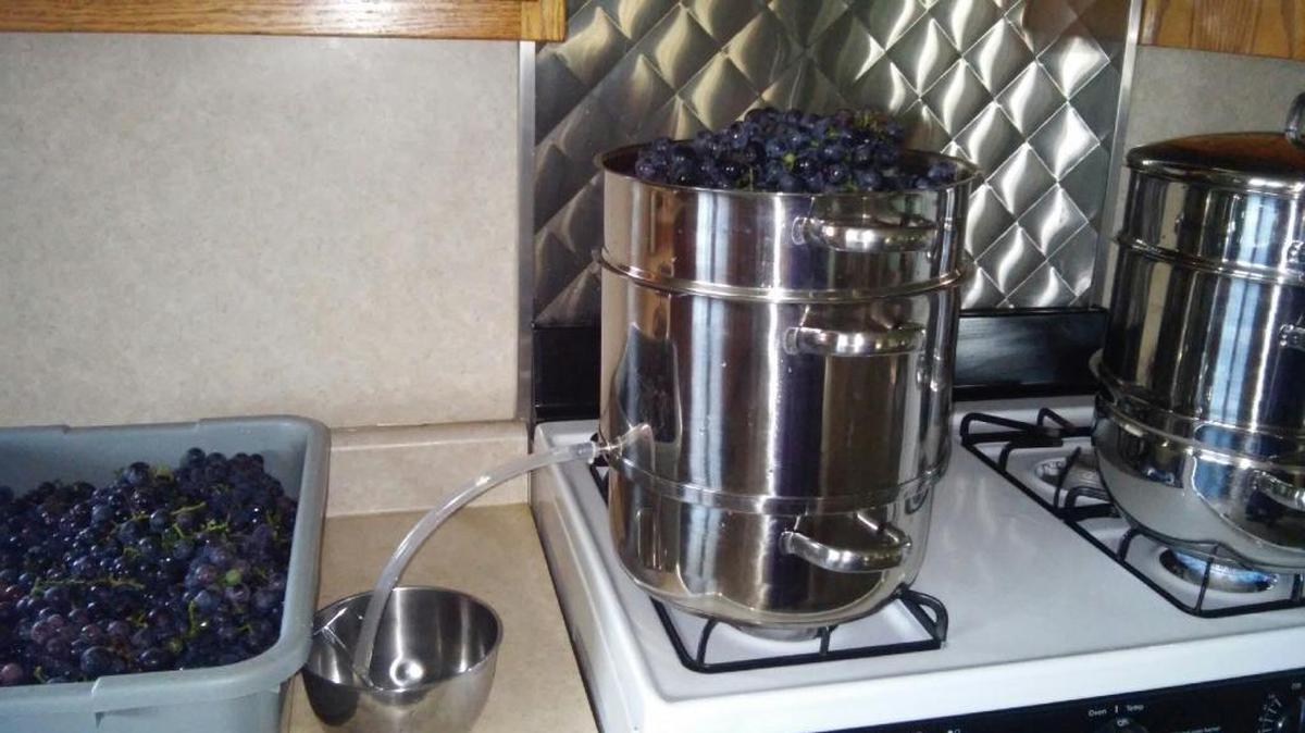Two steamers going on Lovina’s stove make grape juice processing a little faster.