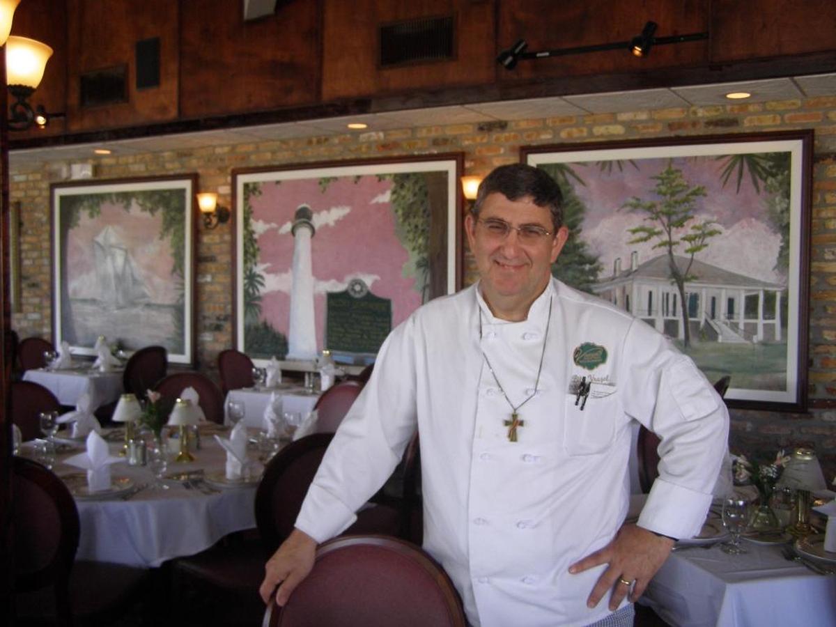 Bill Vrazel, owner of Vrazel’s restaurant in Gulfport, stands in front of a mural that was found and restored after Hurricane Katrina.