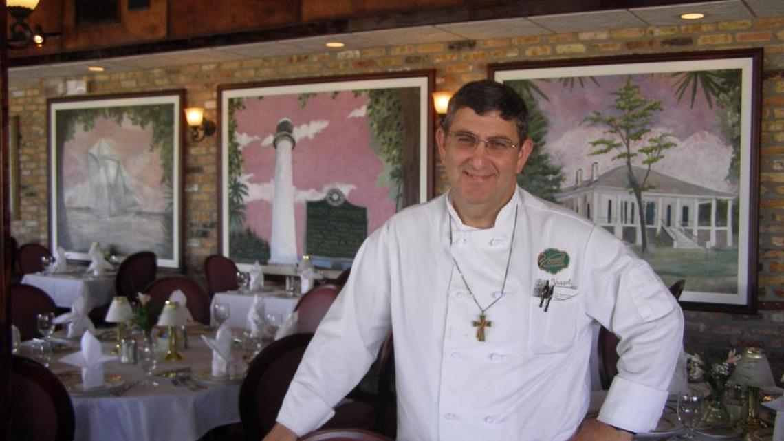 Bill Vrazel, owner of Vrazel's restaurant in Gulfport, stands in front of a mural that was found and restored after Hurricane Katrina.