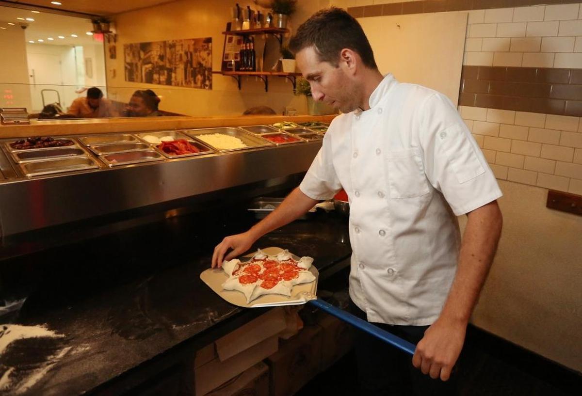 Chef Renato Viola, co-owner of Mister O1, works on creating a Star Luca pizza, a favorite at the Miami Beach pizzeria, on Tuesday, March 6, 2018.