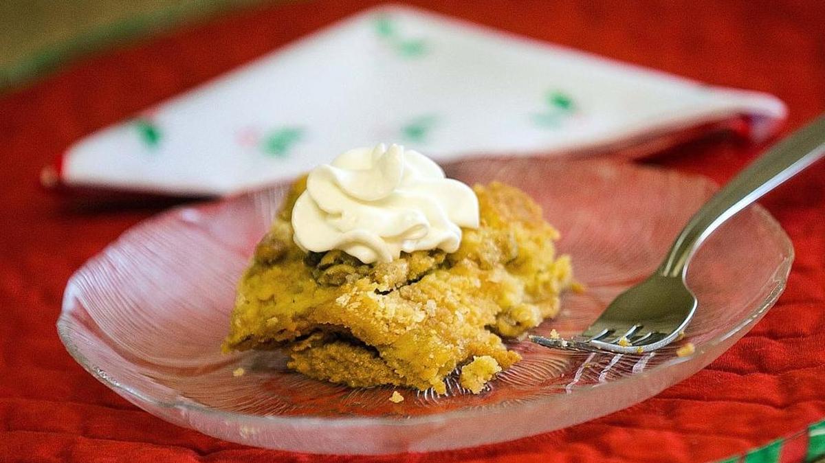 Pumpkin Gooey Butter Cake served with Cool Whip on top is a great menu addition for your Thanksgiving spread.