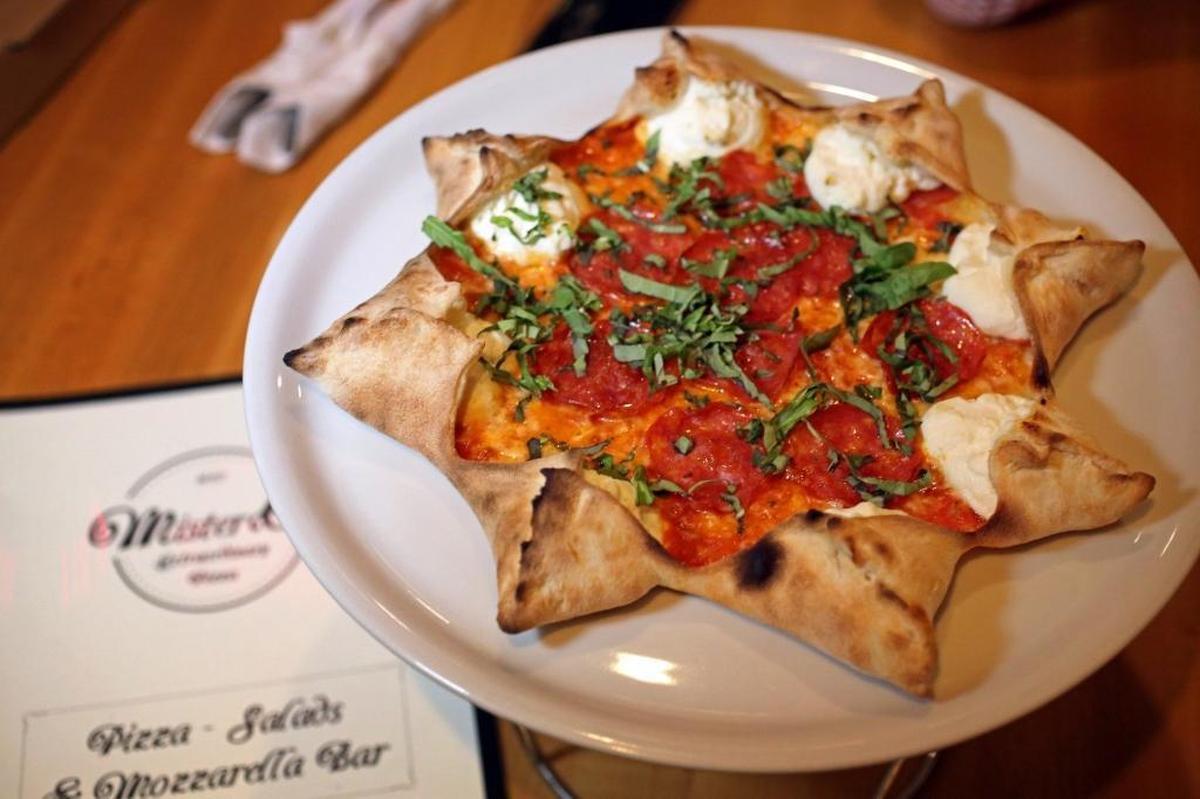 The famous Star Luca pizza at Mister O1 Extraordinary Pizza in Miami Beach. The small pizzeria became a huge hit despite being buried inside an office building with no sign out front. That has led to two other Mister O1 pizzerias, in Brickell and Wynwood.