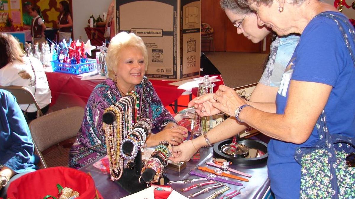 Shoppers at last year’s 21st annual Christmas Market select from an assortment of jewelry.
