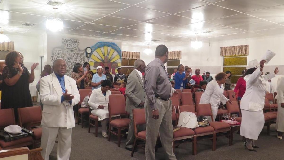 The congregation dances and sings during Tuesday night’s service at First Born Church of the Living God.
