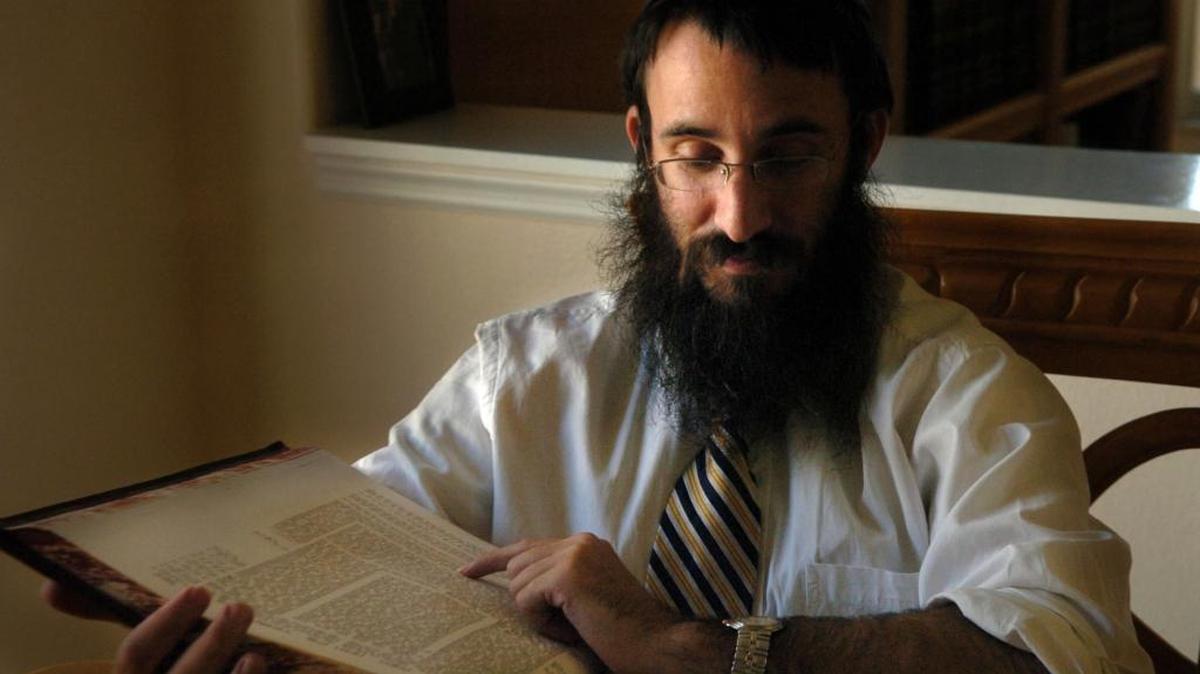 Rabbi Mendy Bukiet, reading from the Talmud, leads the Chabad of Bradenton-Lakewood Ranch.