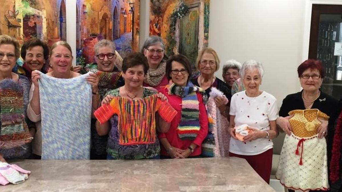 Temple Emanu-El’s Mitzvah Knitting Group displays a few of the handmade items to be sent to Israel, where they are distributed to needy Jewish, Christian and Muslim families. The group meets 10 a.m. June 13 at 151 McIntosh Road in Sarasota.