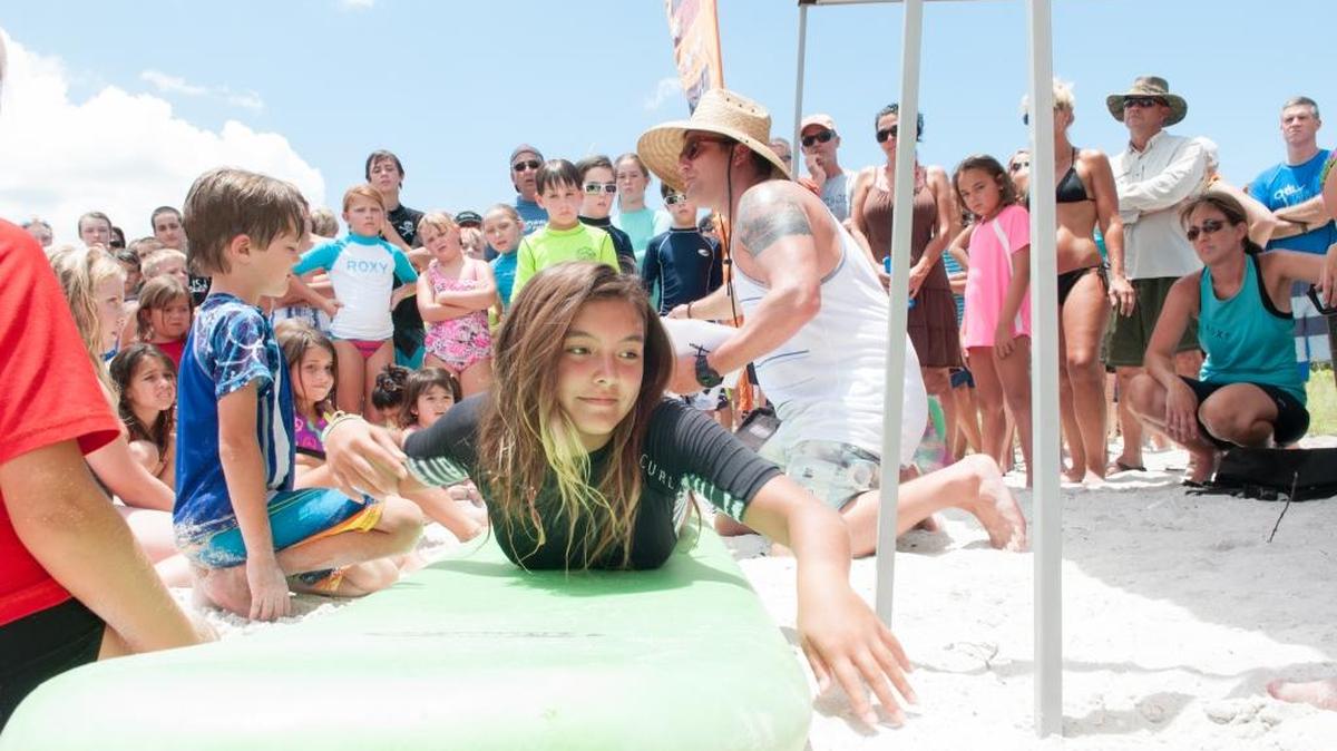 John Bowman teaches children to surf through the Eternal Summer Surf Camp program he founded about 10 years ago.