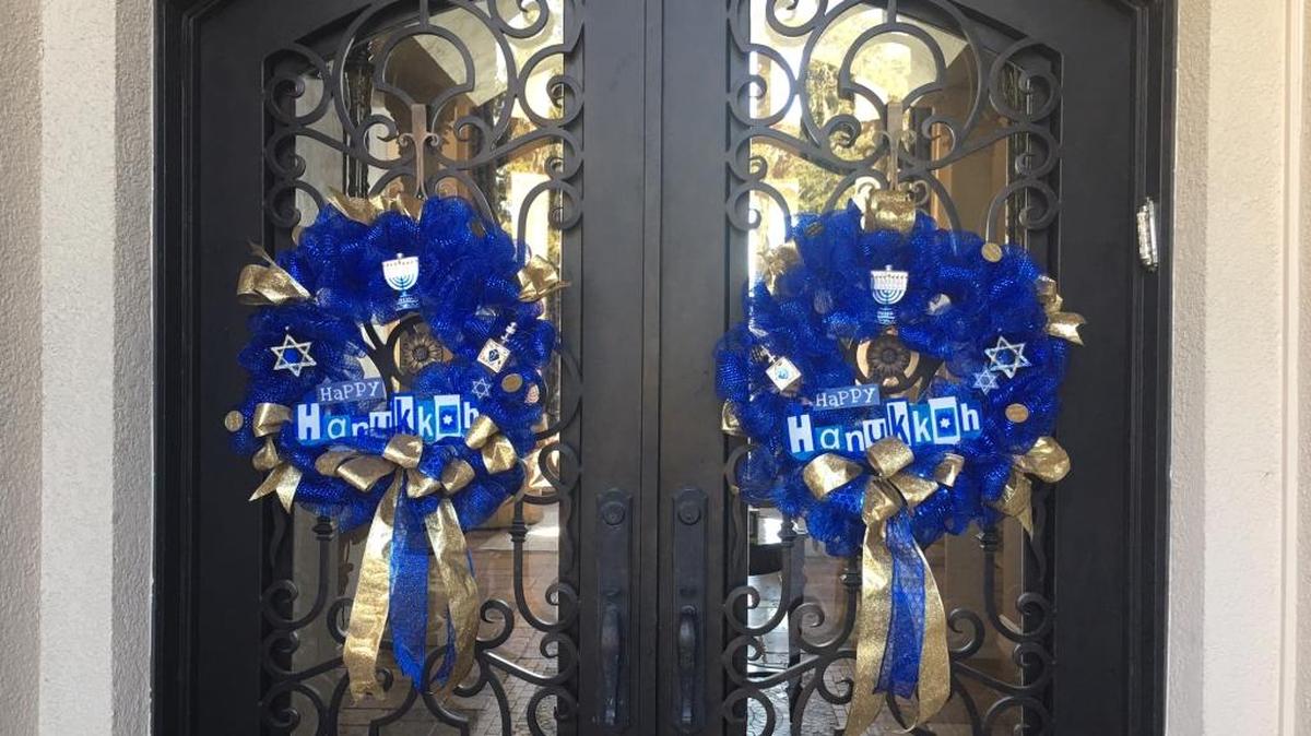 Dr. Richard and Susan Steinberg are opening their 9,266-square-foot home in Palmetto to the Entre Nous Club's 39th Annual Holiday Tour of Homes. The Steinbergs celebrate Hanukkah and the house, above, will have many symbols of the holiday, including the front door blue wreaths. Hanukkah's colors are blue, gold and silver.