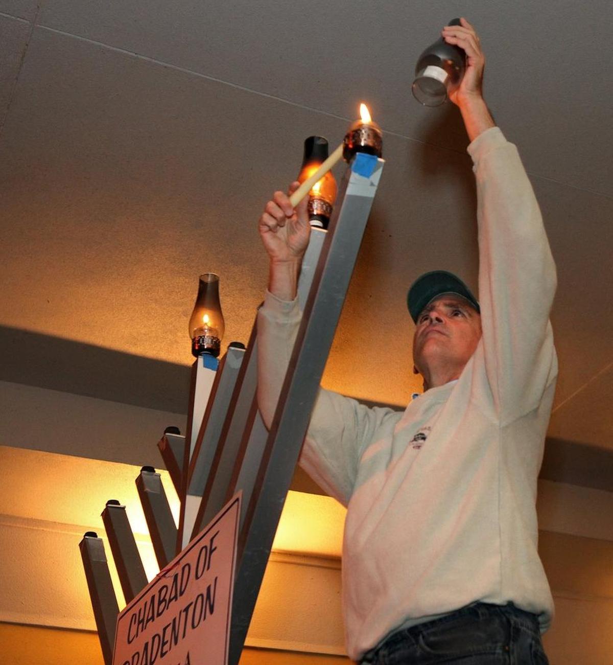 Steve Shapiro lights the Menorah on Main Street at the Lakewood Ranch Chanukah celebration in 2011.