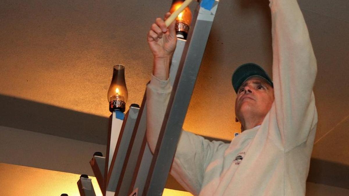 Steve Shapiro lights the Menorah on Main Street at the Lakewood Ranch Chanukah celebration in 2011.