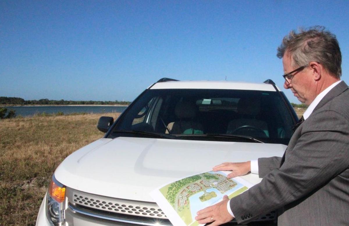 Richard Bedford, vice president of planning for developer Schroeder-Manatee Ranch, looks at a schematic on the site where Waterside Place, the community’s town center, will be located.