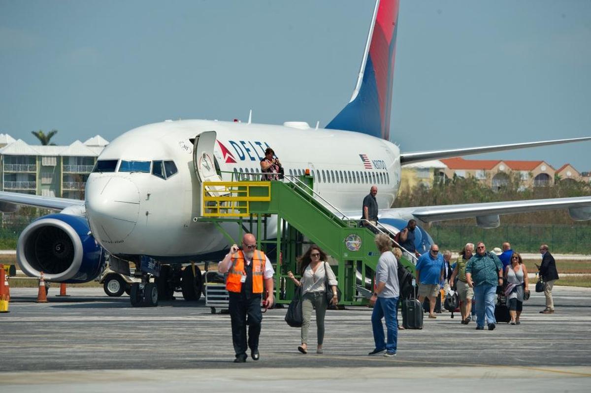 Passengers on a Delta flight from Atlanta walk on the tarmac at Key West International Airport on Sept. 20. The flight was the first commercial airline arrival at Key West since flights were suspended prior to Hurricane Irma.