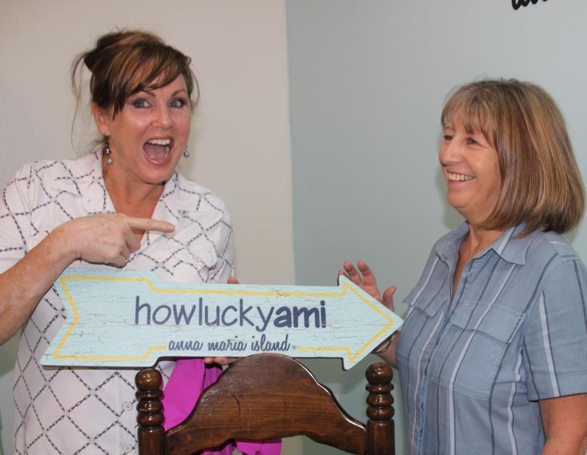Jan Labriola, left, Carol Clifford, right, and Jane Sperlazzi, not shown, promise a sense of fun with their “howluckyami” brand that will be launched Saturday at Restless Natives in Holmes Beach.