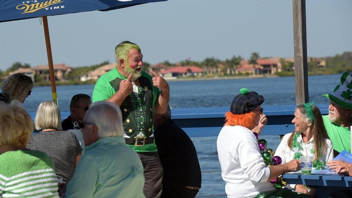 Steve Weed of Minnesota and Palmetto points to the lipstick kisses on his face as he celebrates St. Patrick’s Day on Friday with 16 friends from Frog Creek at the newly-opened Caddy’s at the former Tarpon Pointe Grill & Tiki Bar.