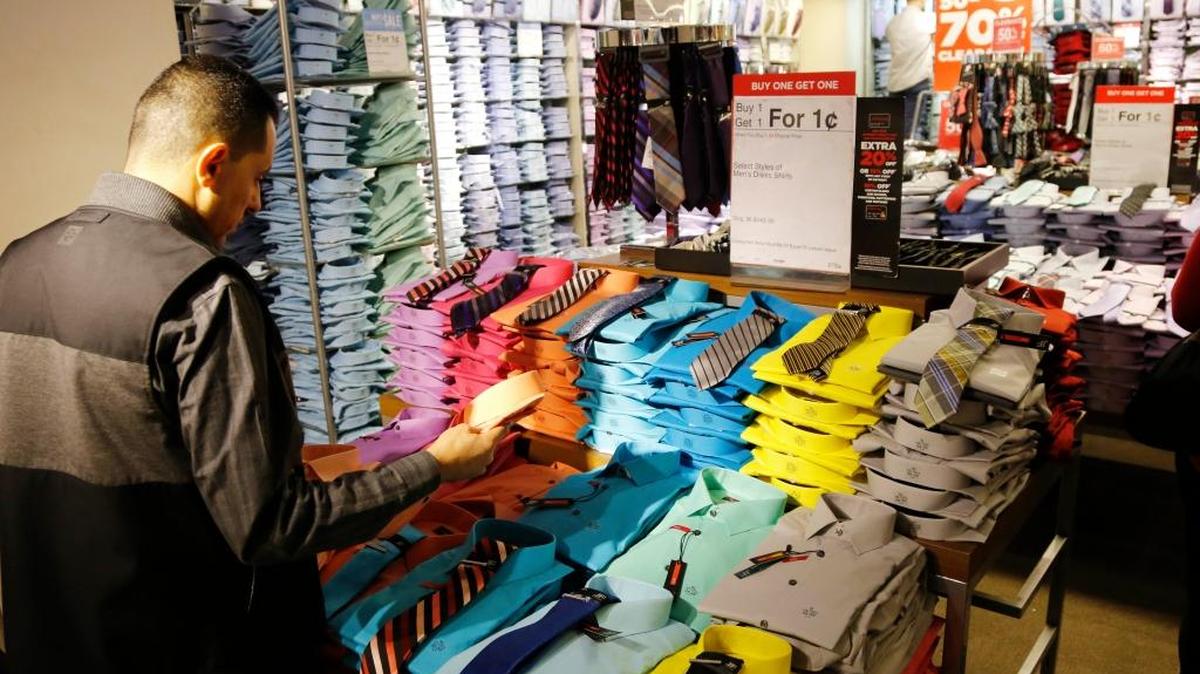 In this March 2016 photo, a man looks at shirts and neckties that are part of a “Buy One Get One for a Penny” sale at a J.C. Penney store. J.C. Penney, Nordstrom, Macy’s and Kohl’s are reinventing themselves amid stiffer competition from online and discount stores like T.J. Maxx. The changes are the most dramatic in the department stores’ storied history.