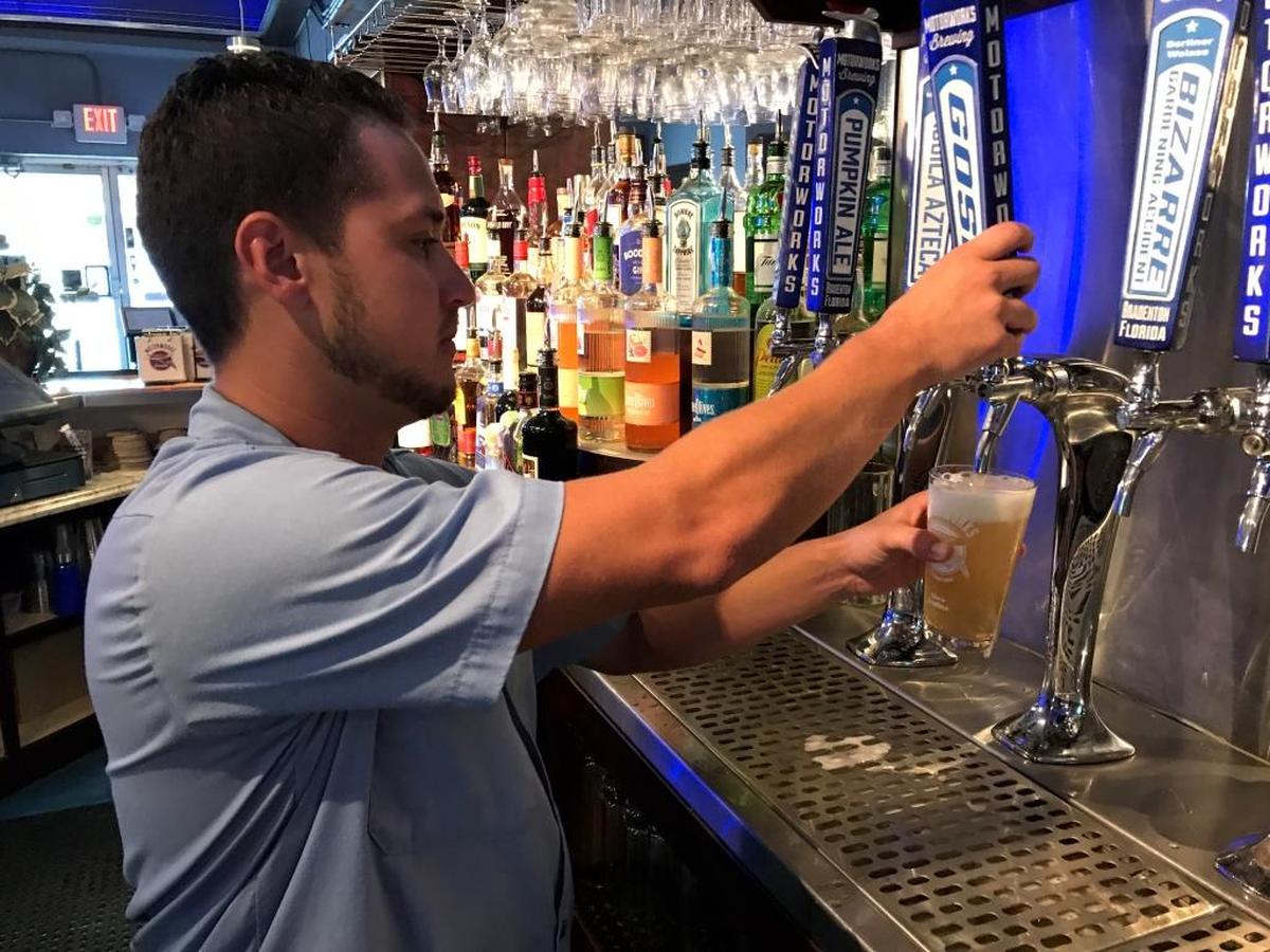 Barry Elwonger draws a beer at Motorworks Brewing on Tuesday. The business closed for the first time its its history on Saturday with the approach of Hurricane Irma.