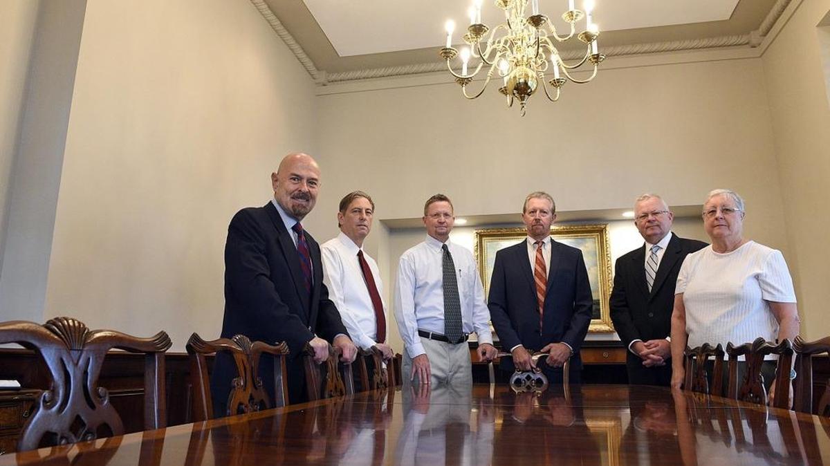 The Harrison and Dye firms, two of Manatee County’s historic firms, have joined forces to become the second-largest firm in the county. From left, Nelon Kirkland, Chuck Pratt, Steve Dye, Joe Harrison, Jim Dye and Patty Petruff.