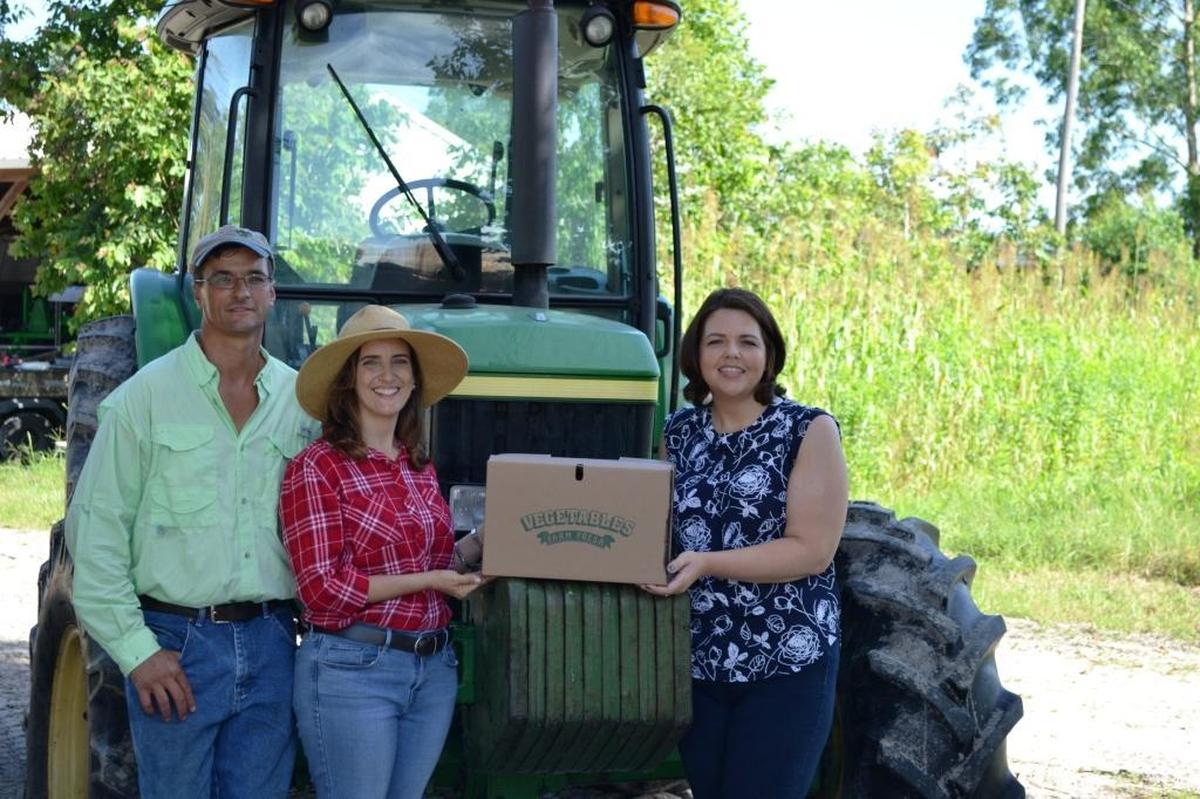 The Market at Lakewood Ranch debuts Wednesday. Subscribers to the Worden Farm veggie box program will be able to pick up their first box of produce at the market. Shown above are Chris and Eva Worden of Worden Farm and Monaca Onstad, director of community relations at Lakewood Ranch.