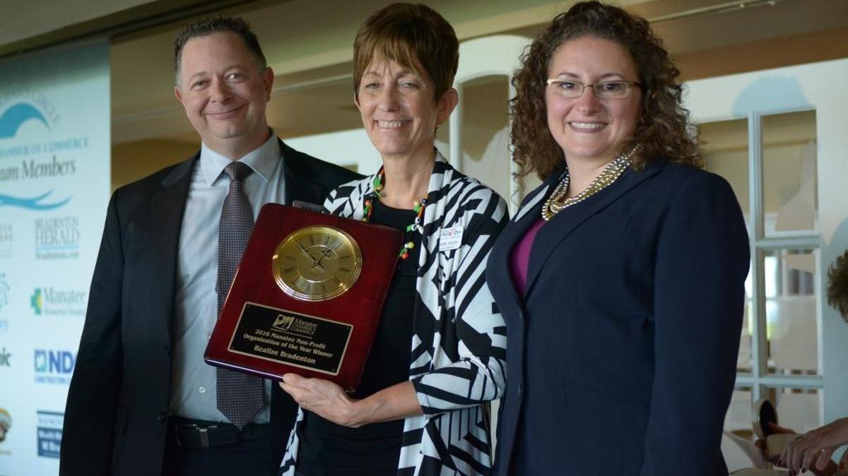 Award Judge Chairman David Spire, left, poses with nonprofit winners Johanette Isham, center, and Catherine Ferrer, right, representing Realize Bradenton. The 37th Annual Manatee Small Business of the Year awards were handed out at a luncheon Friday at IMG Academy Golf Club.