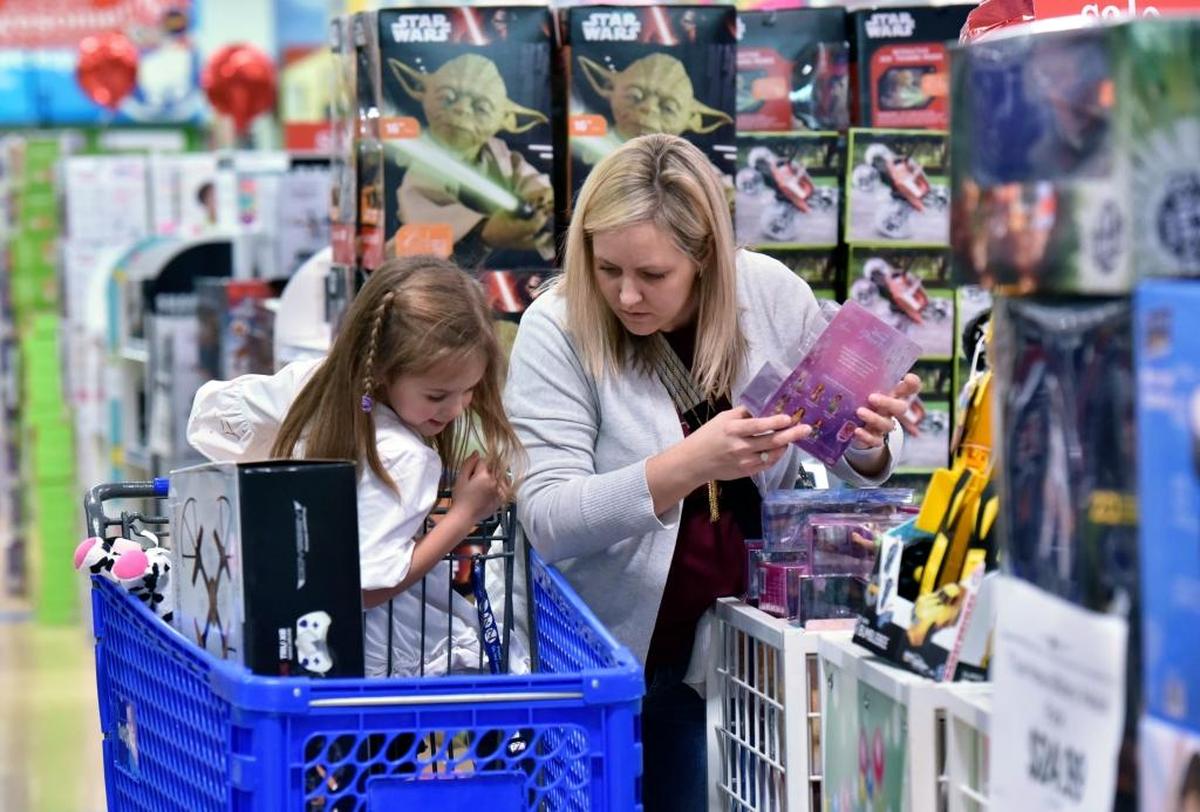 In this 2016 file photo, Stephanie Rowell and her daughter Sydney, then-5, shopped at a Toys R Us in Georgia at the height of Christmas season.