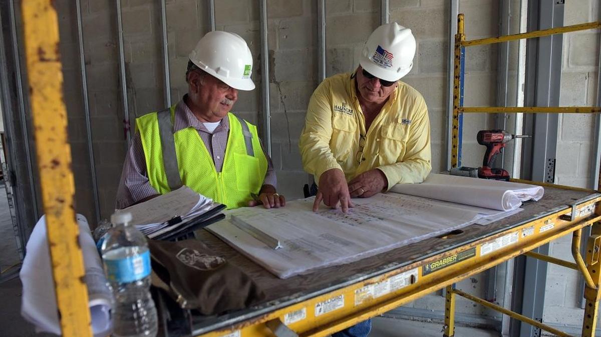 Ken Hinkle project manager for the SRQ Airport Authority and Mike Lawton, Superintendent for Halfacre Construction look over blueprints in a new administration building. The Sarasota-Bradenton International Airport progresses on a new $25 million air traffic control tower, which is one capital improvement project in SRQ’s five-year capital improvement plan.