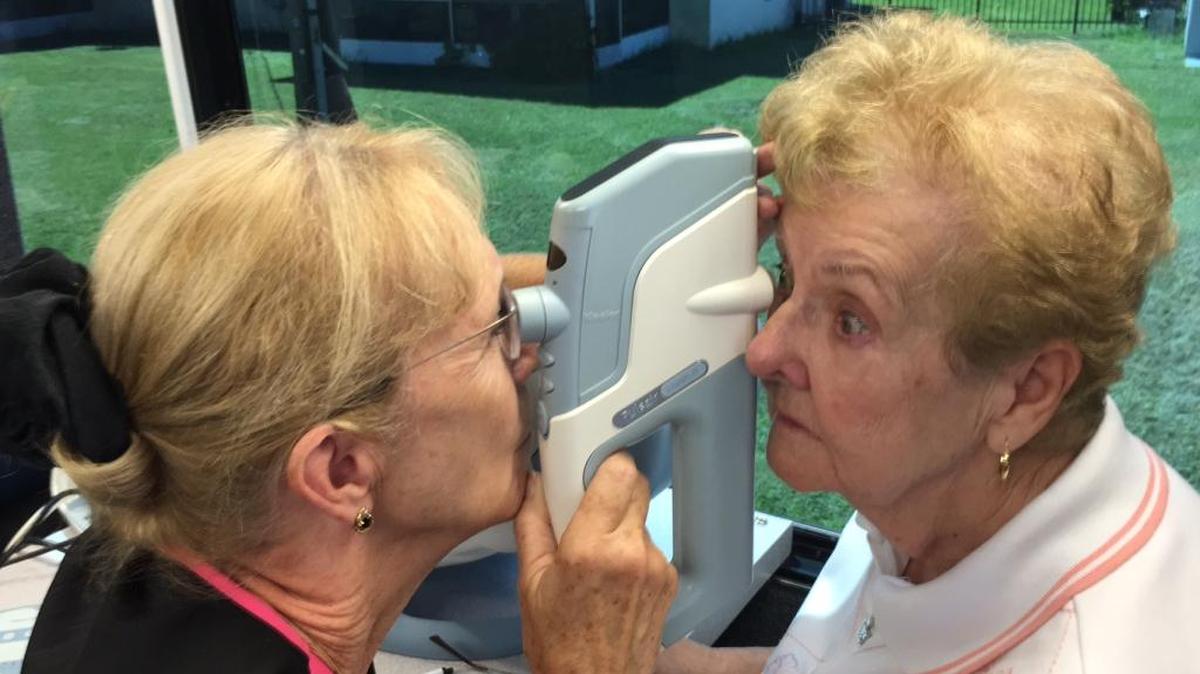 Sandra Shadwill, left, an employee of The Eye Associates, checks Ellenton’s Betty Downs for glaucoma Thursday. Downs came to Church of the Cross in Bradenton Thursday for a free eye exam in The Eye Associates’ new SightMobile.