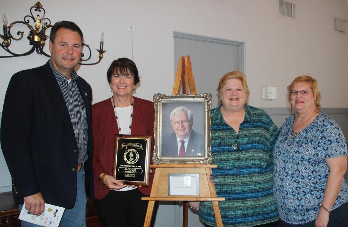 Dan West inducted the late Jack Gay, a dairyman, beef rancher, citrus grower and community leader, into the Manatee County Agricultural Hall of Fame on Thursday. He is shown with Mr. Gay’s daughters, from left, Brenda Rogers, Linda Gay and Kathi Durrance.