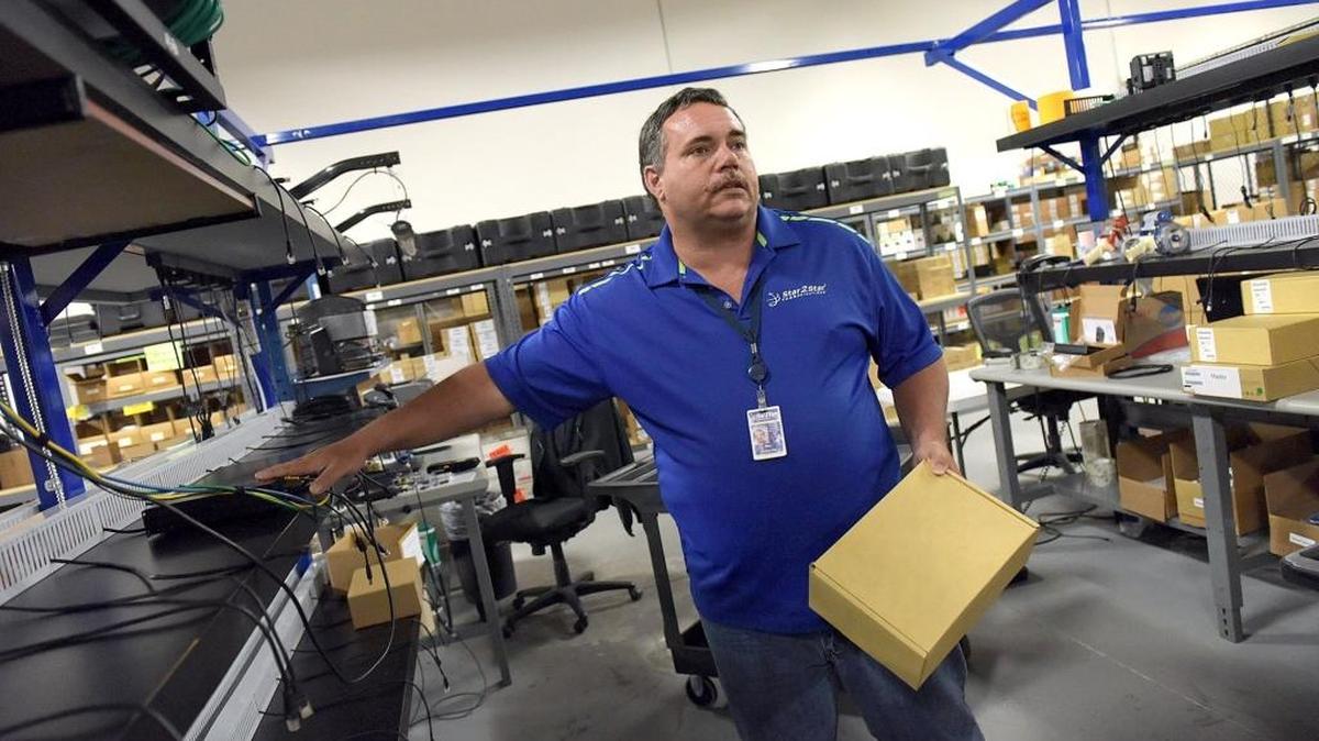 Bill LaMoore, a build specialist, describes how he tests each unit before shipment to clients at Star2Star. Star2Star Communications is one of 67 local companies who have contracted with Manatee County for economic development incentives since 2009.