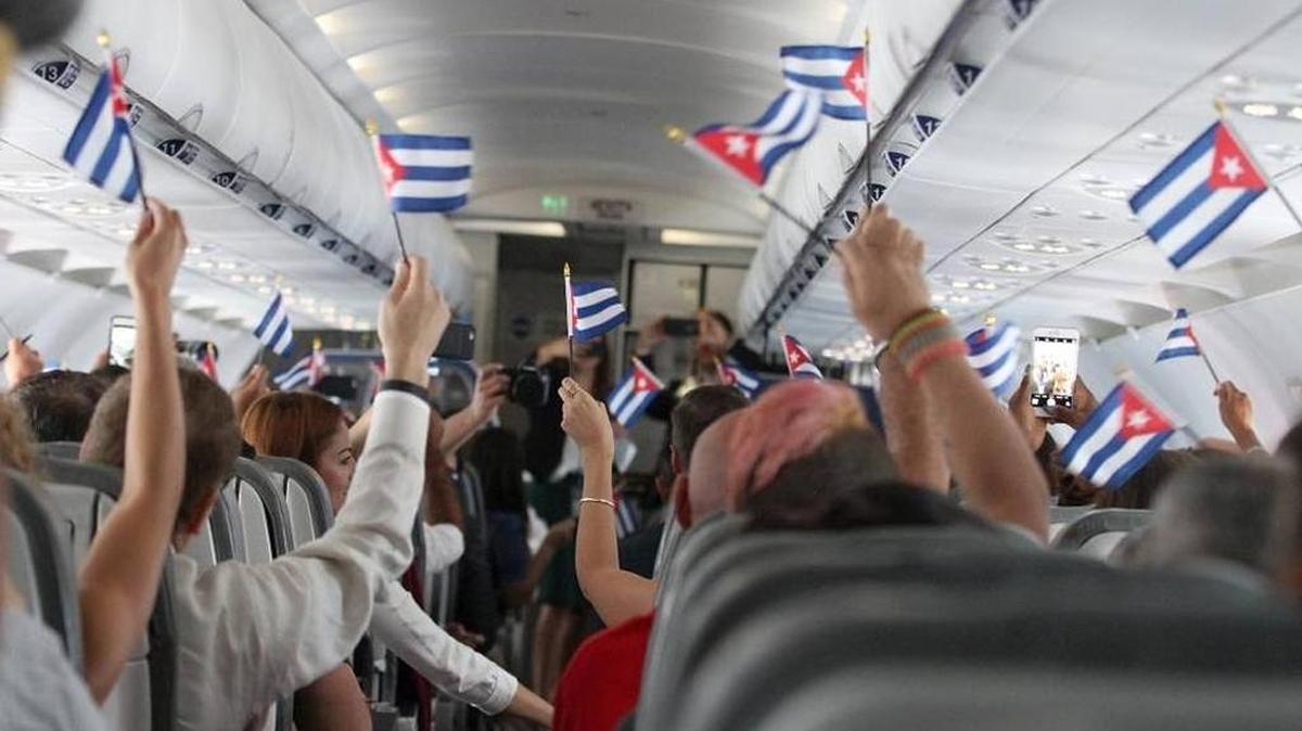 Customers wave Cuban flags shortly after take-off from Fort Lauderdale airport during JetBlue’s inaugural commercial flight to Cuba on Aug. 31. JetBlue flights to Cuba are among those being offered by CheapAir.com.