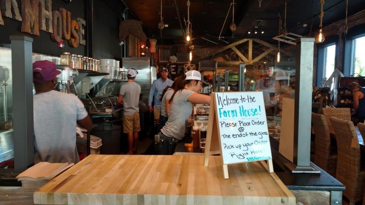 Employees use fresh ingredients to prepare miniature doughnuts. A half-dozen costs $4.50, while a dozen goes for $9.