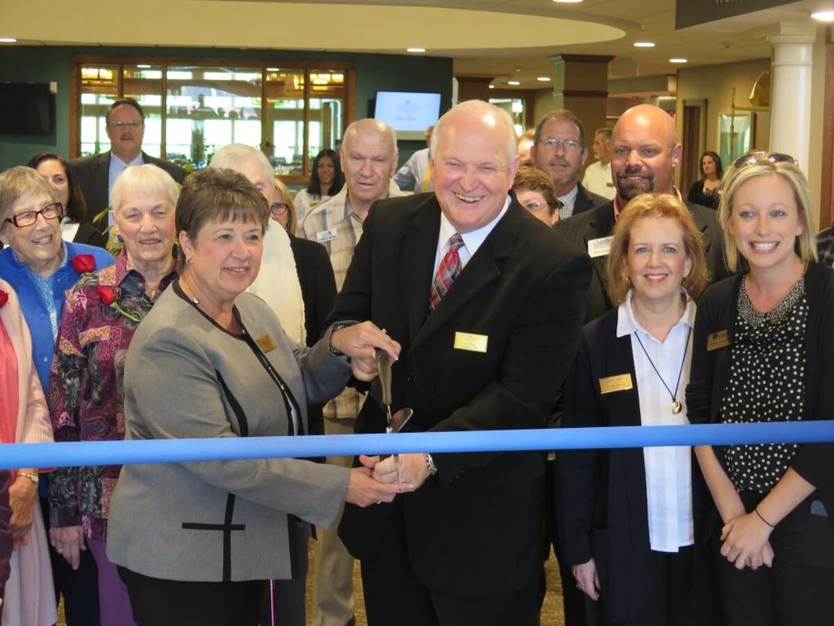 Live-in managers Sheri and Ed Ring cut a ribbon during Stone River Retirement Community’s grand opening Thursday morning.