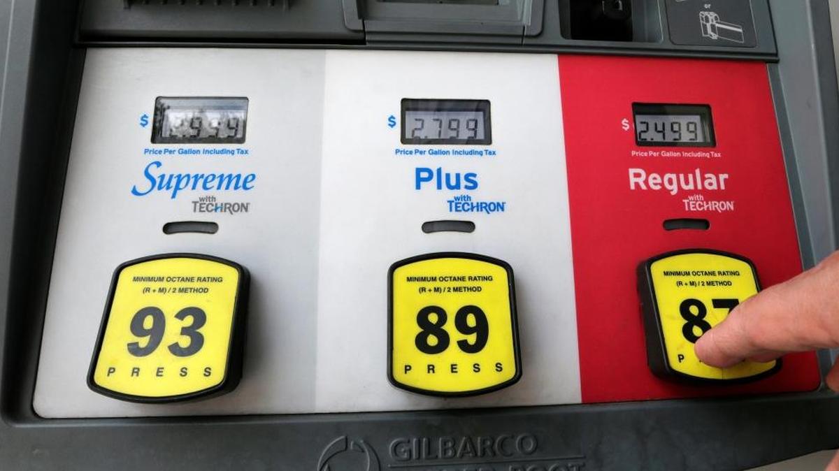 A motorist prepares to select regular gas at a pump at a station in Miami.