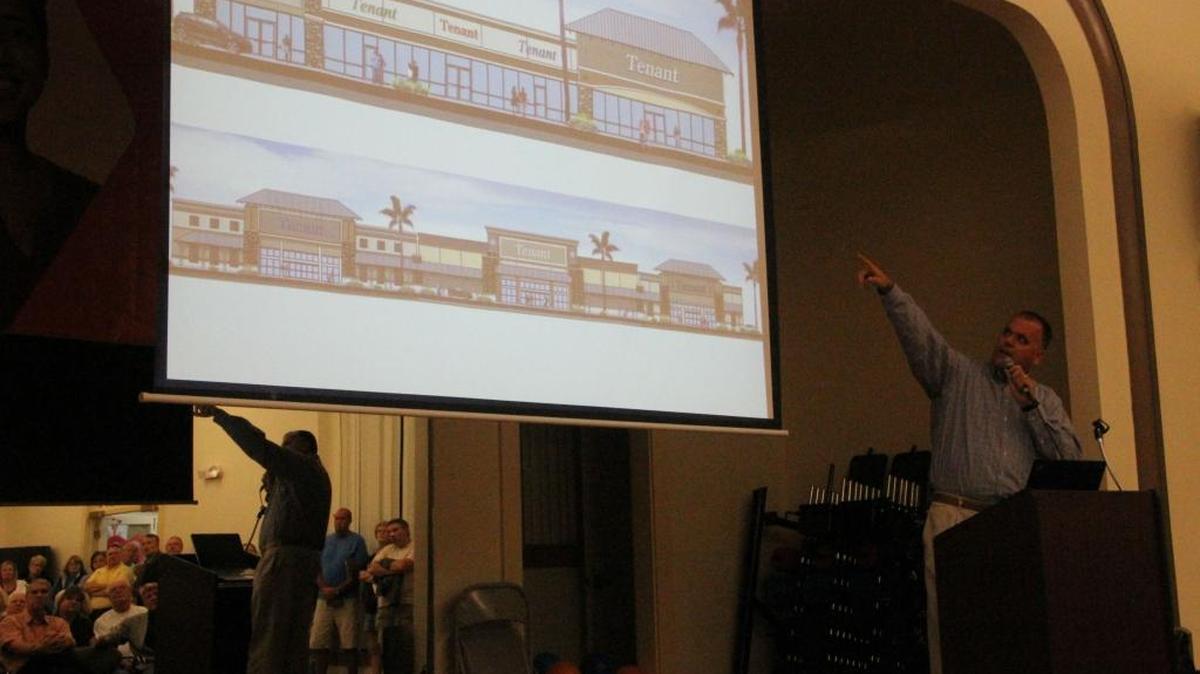 Todd Mathes of Benderson Development points to an artist’s conception of a portion of a shopping center being developed in Parrish. Mathes briefed residents on plans for the shopping center Thursday night.