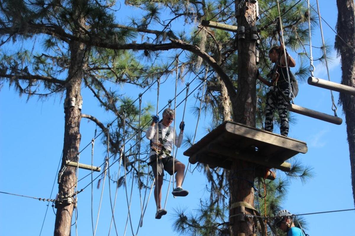 Mark Rolewski gets his legs on one of the courses at TreeUmph! Adventure Course in East Manatee. A second TreeUmph! is opening soon in Brooksville.