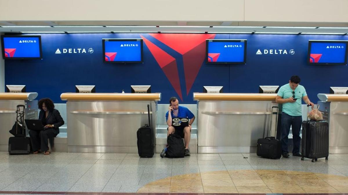 In this Monday, Aug. 8, photo, passengers wait at Hartsfield-Jackson Atlanta International Airport.
