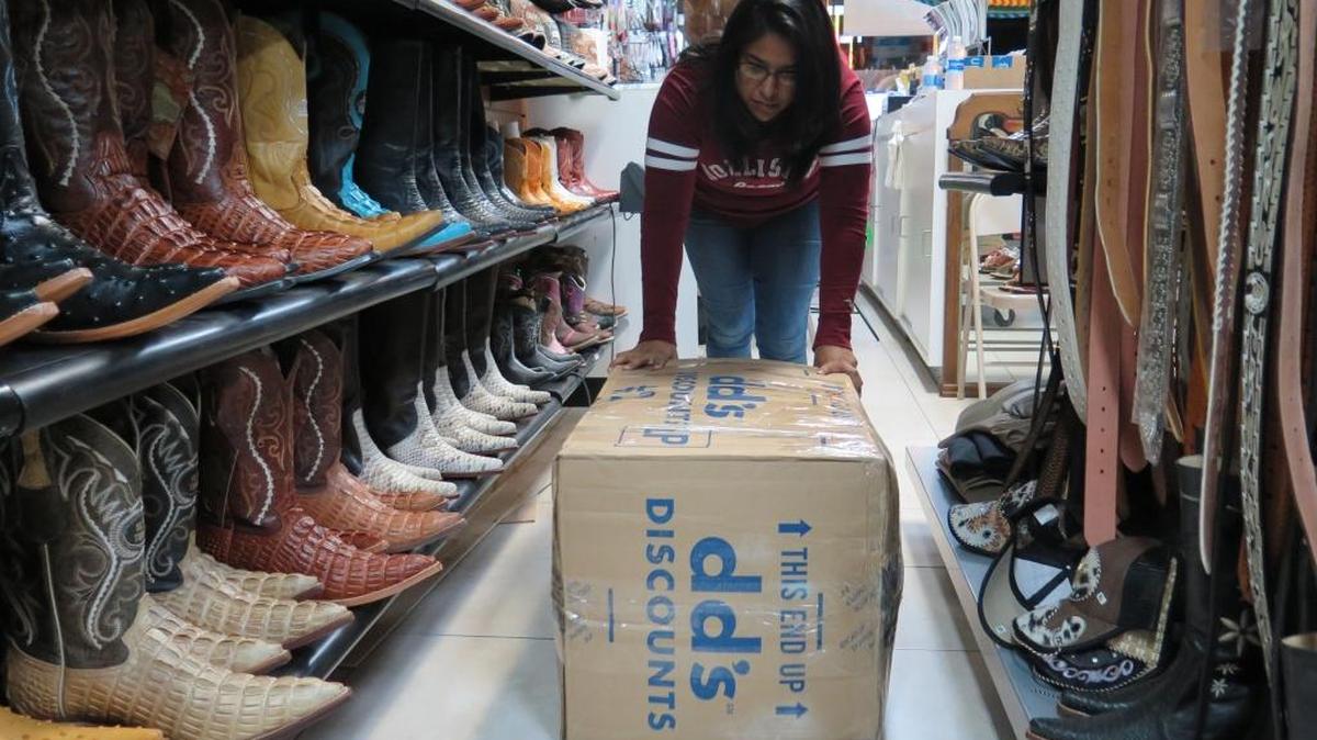 In this portrait, Ana Rangel, co-owner of El Chacharas in Bradenton, pushes a box filled with items toward the back of her business. The box later would be sent to Mexico, along with other packages.