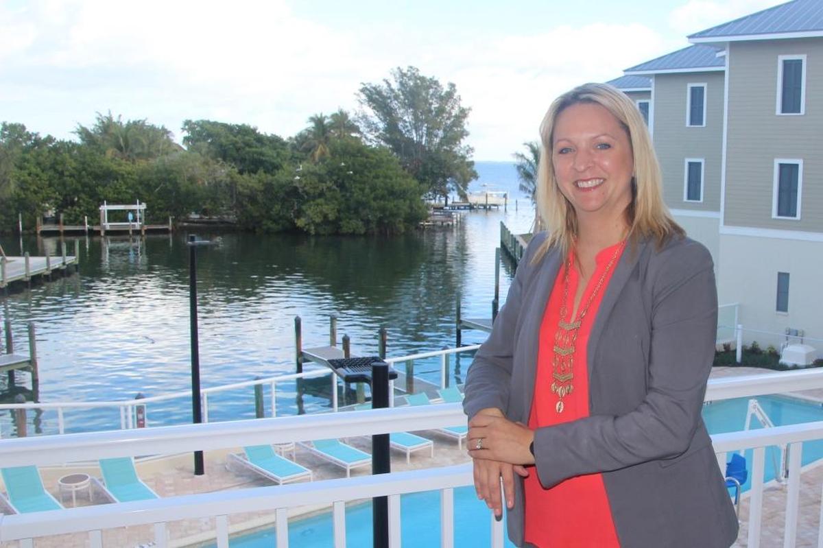Sandy Zinck, general manager of Waterline Marina Resort & Beach Club, stands on a walkway overlooking the play deck, swimming pool, marina and Sarasota Bay.