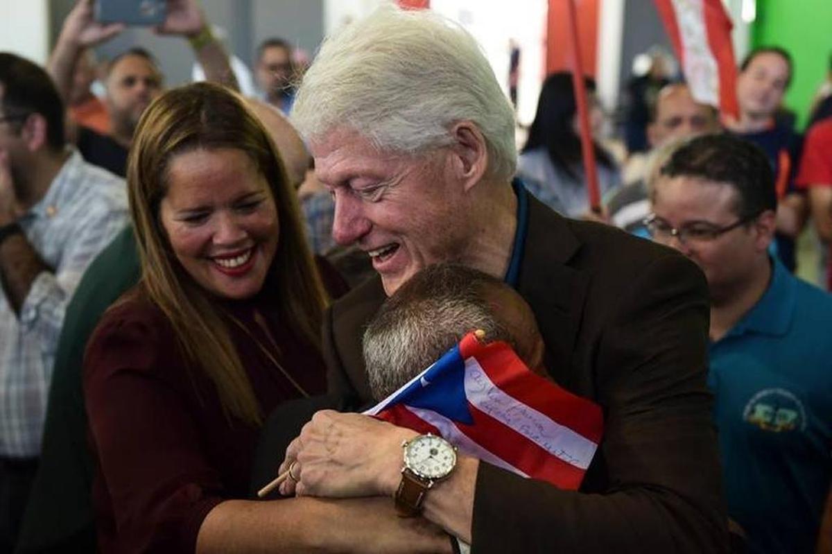 Former President Bill Clinton hugs a resident living at the William Rivera Betancourt Vocational School, which was turned into an emergency shelter for families affected by Hurricane Maria, last week in Canovanas, Puerto Rico.