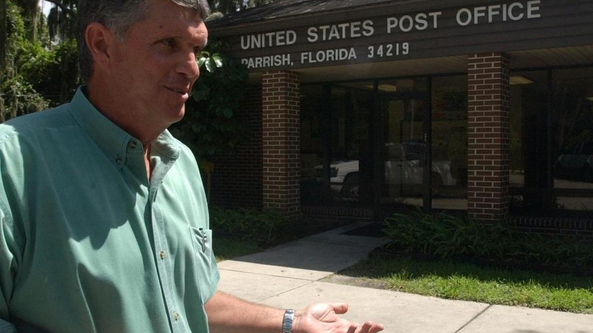 Ben Jordan, president of the Parrish Civic Association, stands in front of the former Parrish Post Office in 2006. Alan Jones is making plans to expand the building and open a shopping center there.
