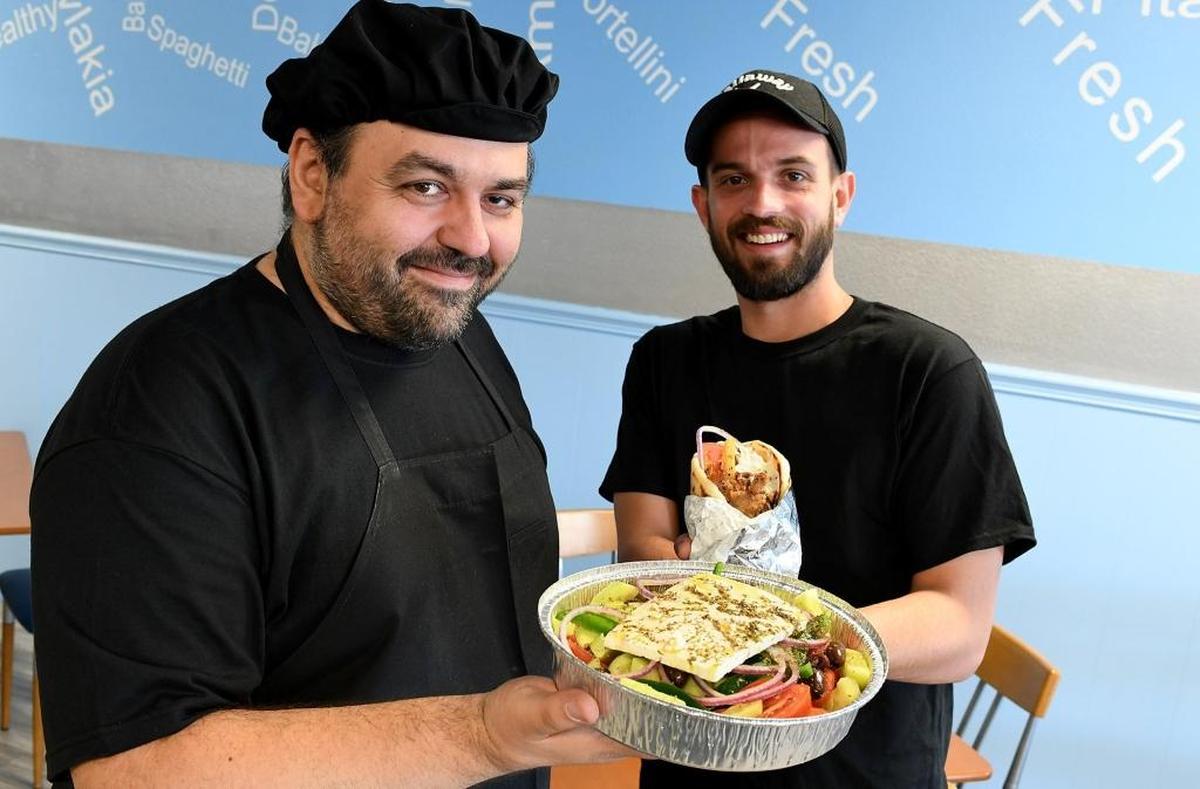 All Greek consultant Spyros Marinos and owner Brandon Kern hold servings of food at their new restaurant, which is located at 4816 14th St. W. in Bradenton.
