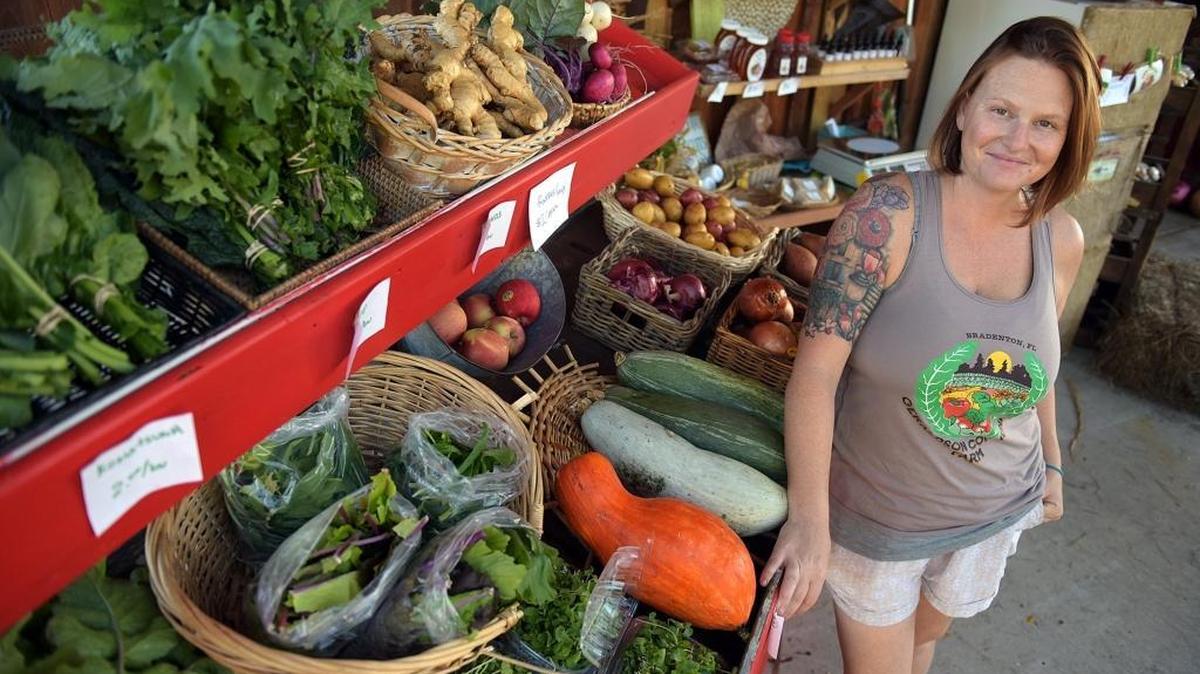 The retail spot in front of the Geraldson Community Farm's barn with farm manager Christa Leonard displays a variety of vegetables and greens.