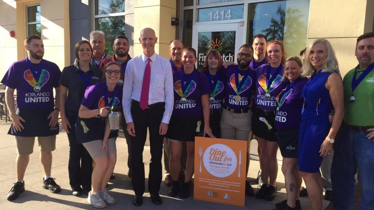 Florida Gov. Rick Scott poses for a photo on June 30 with First Watch employees in Orlando during the Dine Out Orlando fundraiser.