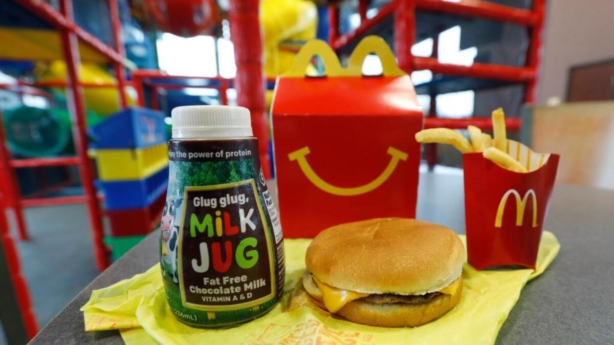 A Happy Meal featuring non-fat chocolate milk and a cheeseburger with fries, are arranged for a photo at a McDonald's restaurant in Brandon, Miss., Wednesday, Feb. 14, 2018. McDonald’s will soon banish cheeseburgers and chocolate milk from its Happy Meal menu in an effort to cut down on the calories, sodium, saturated fat and sugar that kids consume at its restaurants. Diners can still ask specifically for cheeseburgers or chocolate milk with the kid’s meal, but the fast-food company said that not listing them will reduce how often they’re ordered.